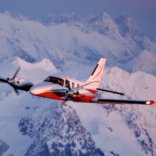 Piper Seneca V flying near mountain